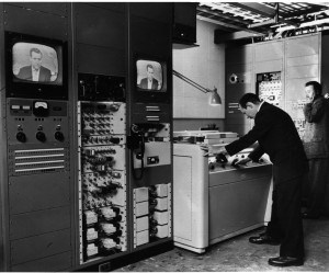 Engineer John Radis monitors operation of Ampex VRX-1000 at CBS Television City in Hollywood as Douglas Edwards reports the news in New York.